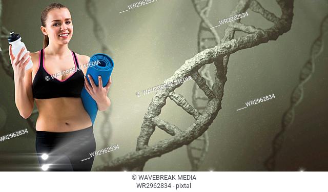 Woman holding yoga mat and bottle against DNA structures
