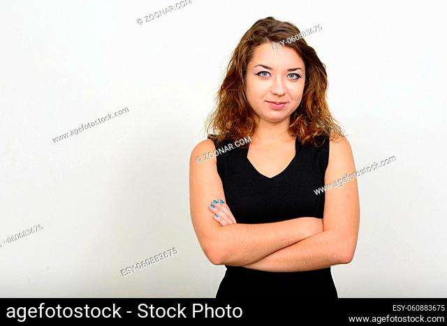 Studio shot of young beautiful woman with brown hair against white background
