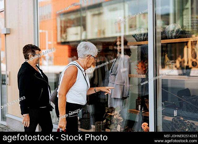 Senior women looking at shop window