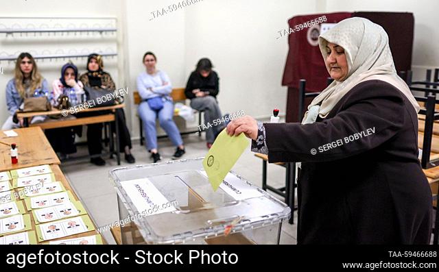 RUSSIA, ISTANBUL - MAY 28, 2023: A voter casts her ballot at a polling station in Saffet Cebi Middle School during a runoff between incumbent president Erdogan...