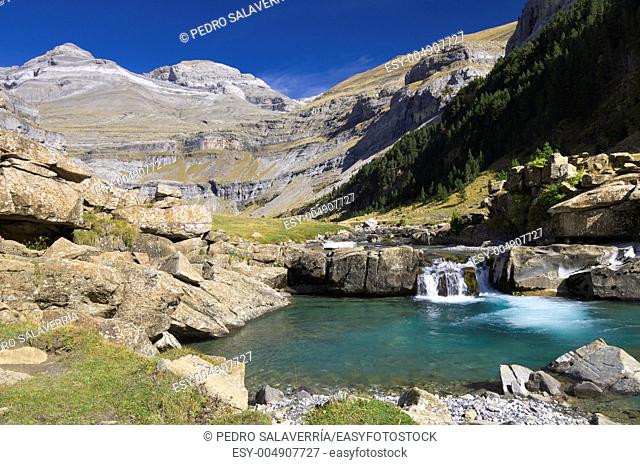 view of a waterfall and Monte Perdido peak in the valley of ordesa, Pyrenees, Huesca, Aragon, Spain