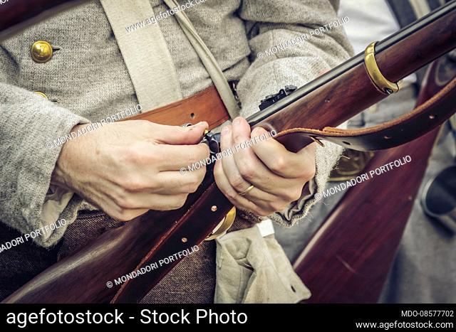 American Civil War: Confederate Army. Detail of a percussion muzzle-loading rifle. Inserting the detonation cap. Peschiera del Garda (VR) 19th Sptember 2009