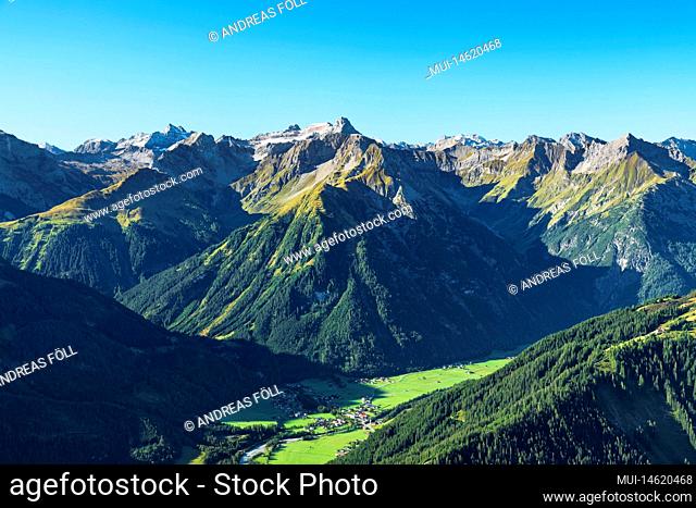 Alpine mountain landscape on sunny summer day. View to Lechtaler Alps above Lechtal valley near Bach. Tyrol, Austria, Europe