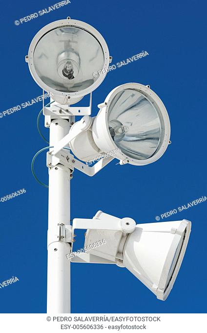 view of a modern urban streetlight white with clear blue sky