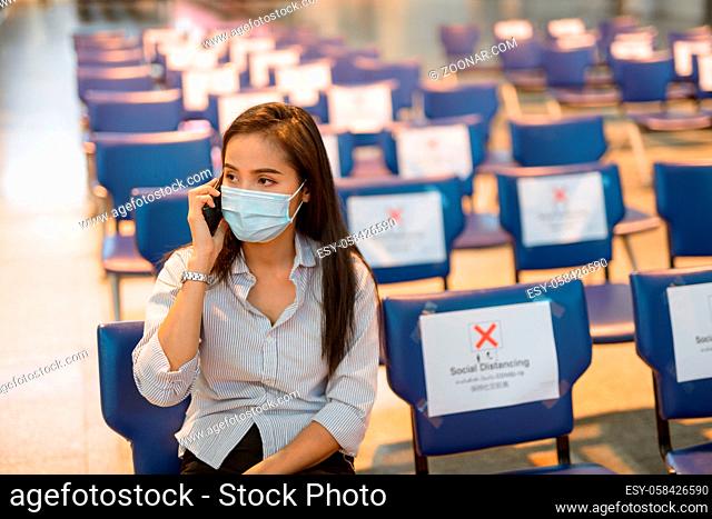 Portrait of young Asian tourist woman with mask for protection from corona virus outbreak social distancing at the airport