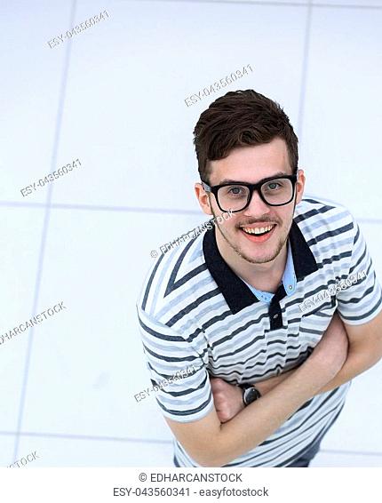 successful young man with glasses looking at camera. isolated on white background