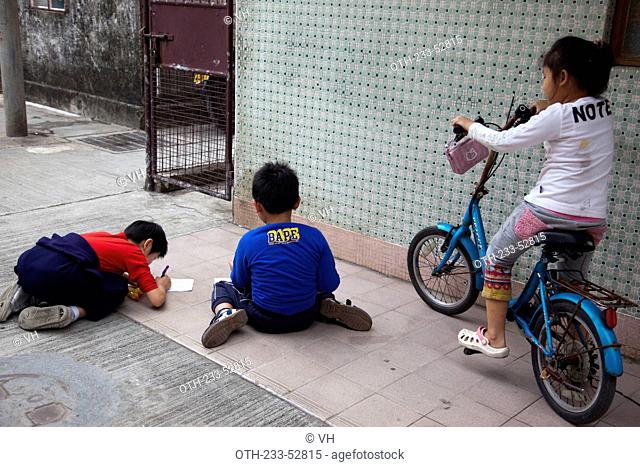 Children playing at the alley of their home at Kam Tin, New Territories, Hong Kong