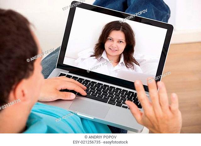 Man Video Conferencing With Woman