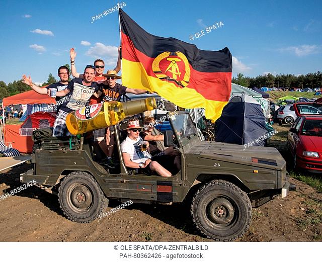 Festival visitors on a Bombardier Iltis from 1987 during the 'Sputnik Springbreak' music festival on the peninsular Pouch near Bitterfeld, Germany, 13 May 2016