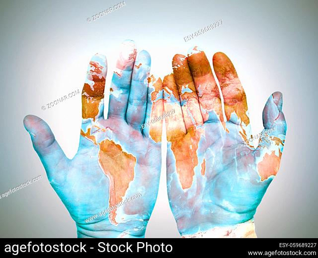 Two male palms with superimposed world map as global awareness and care concept