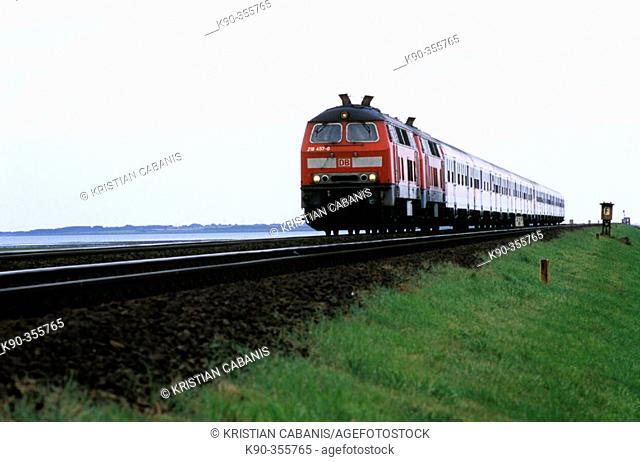 Regional train of Deutsche Bahn with diesel locomotive in double track on the Hindenburgdamm that connects Sylt island with the mainland