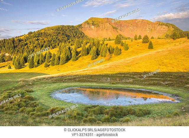 Sunrise on Peller mount reflected into the lake of the Vipers, Cles, Non valley, Trento province, Trentino Alto Adige, Italy, Europe