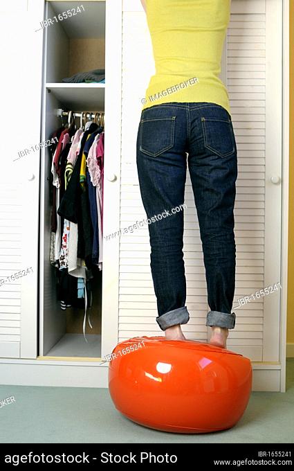 Girl doing putting clothes away