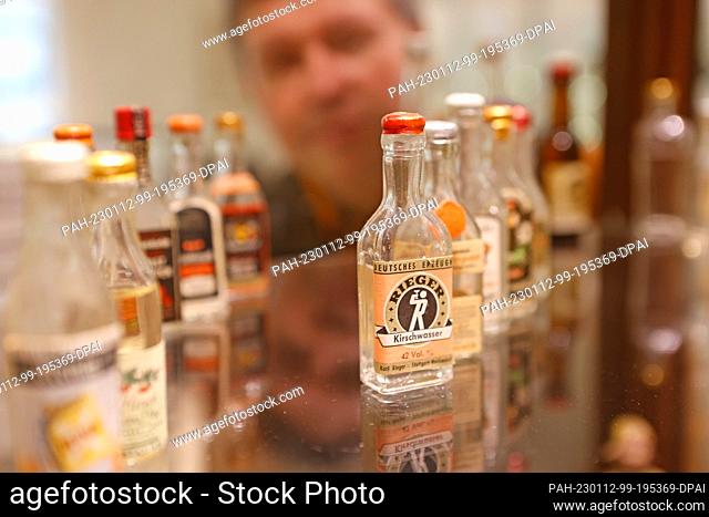 12 January 2023, Thuringia, Nordhausen: Miniature bottles stand on a glass display case in the traditional Nordhausen distillery
