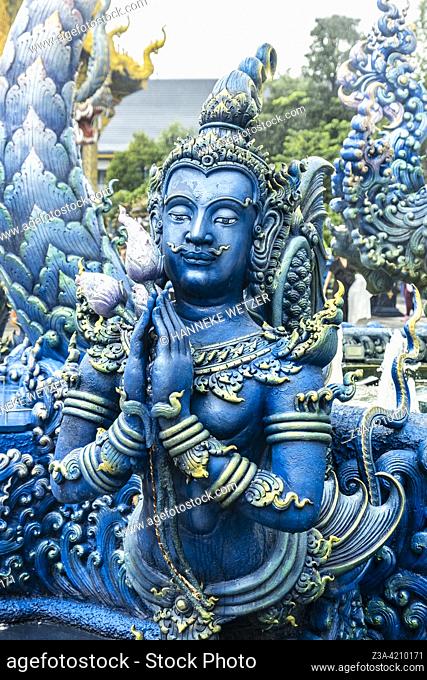 Blue figure at the Blue Temple (Wat Rong Suea Ten or Temple of the Dancing Tiger) in Chiang Rai, Thailand, Asia. Blue is symbolically associated with purity