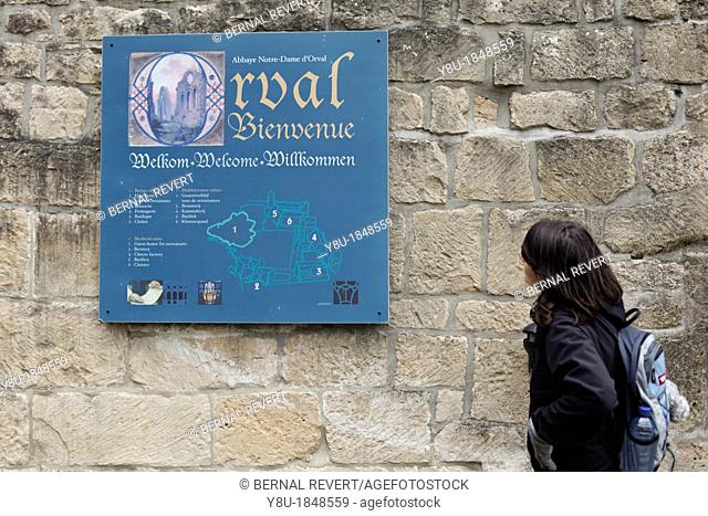 A tourist looks at the entrance sign at Orval Abbey in Villers-Devant-Orval, Belgium