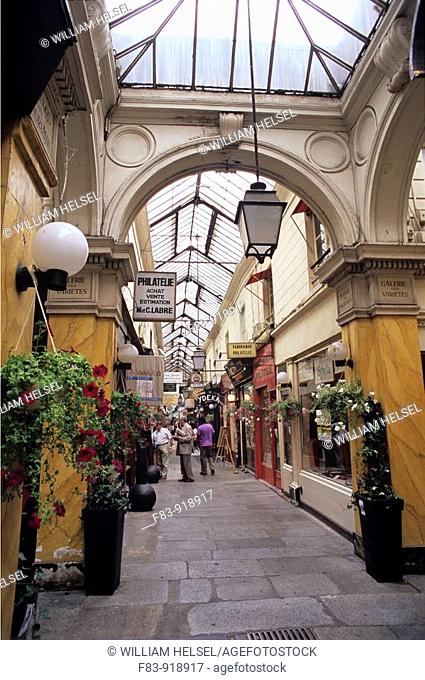 France, Paris, 2nd arrondissement, Passage des Panoramas, a covered pedestrian shopping gallery or 'passage couvert' with skylight, stone paving, stamp dealers