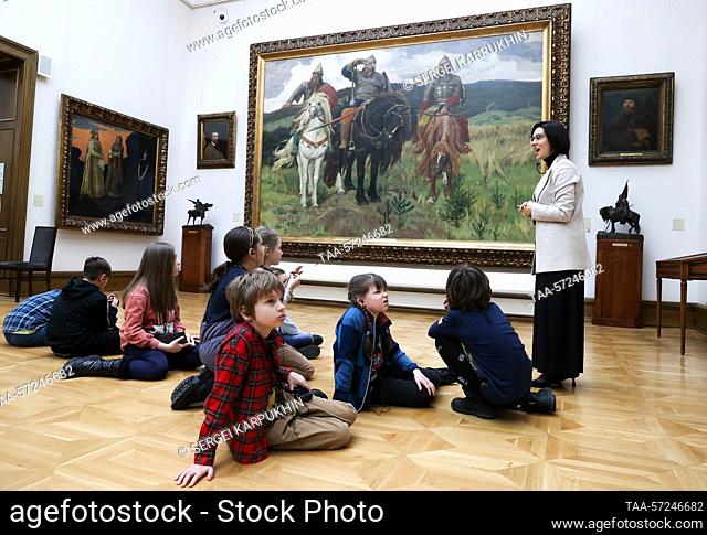RUSSIA, MOSCOW - FEBRUARY 8, 2023: People are seen by Bogatyrs (1898) by Russian artist Viktor Vasnetsov at the State Tretyakov Gallery