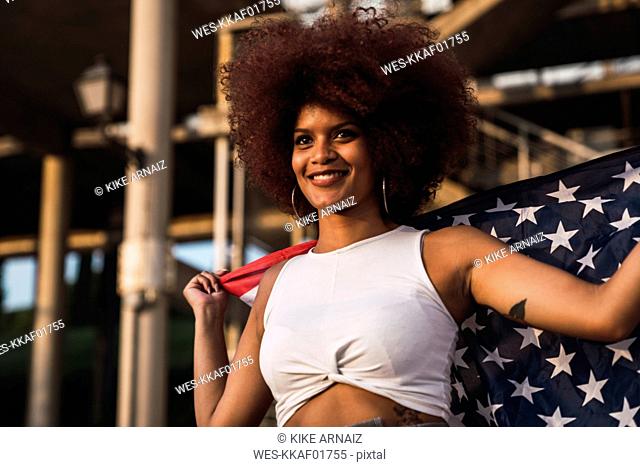 Portrait of smiling young woman with American flag