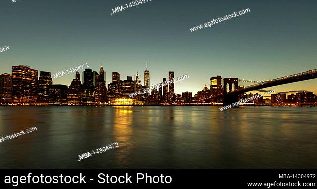 DUMBO/Fulton Ferry, New York City, NY, USA, The skyline of New York/Manhattan and Brooklyn Bridge over East River shortly after sunset