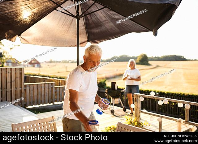 Man standing by table in garden