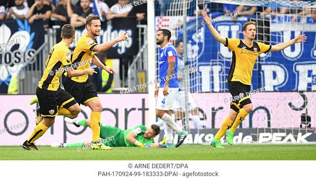 Dresden's Paul Seguin (L-R), scorer Manuel Konrad and Jannik Mueller cheer over the 3-1 score during the German 2. Bundesliga match between SV Darmstadt 98 and...