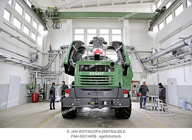 Several employees do the quality check of a Fendt Katana 65 corn chopper in a former tank maintenance hall in Hohenmoelsen, Germany, 17 April 2015