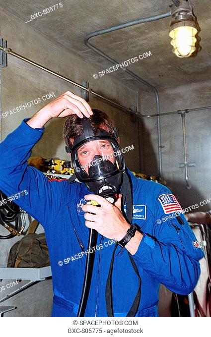 07/19/2001 -- At Launch Pad 39A, STS-105 Commander Scott Horowitz puts on a gas mask as part of Terminal Countdown Demonstration Test activities