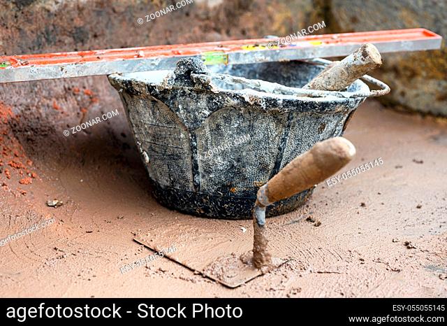 Construction tools background, bucket trowel and level