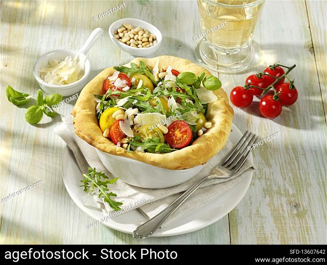 Rocket and tomato salad in a bread dough basket