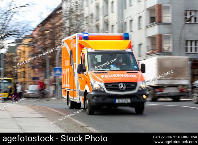PRODUCTION - 25 February 2022, Berlin: An ambulance of the fire department is driving on a road. (Shot with long exposure) Photo: Fernando...