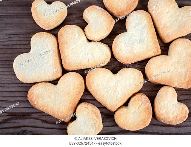 Heart shaped cookies on wooden background. Top view