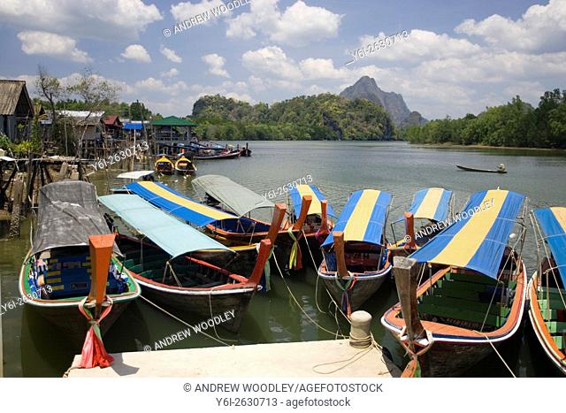 Covered tourist longtail boats for excursions into Phang Nga Bay Thailand