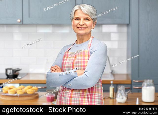 portrait of smiling senior woman at kitchen