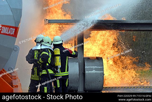 29 March 2022, Thuringia, Erfurt: Firefighters extinguish flames on a fire simulator at Erfurt-Weimar Airport. The mobile airport fire simulator from ARFF...
