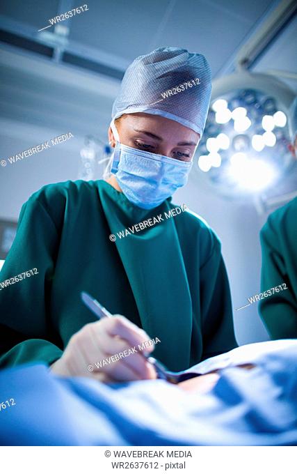 Female surgeon performing operation in operation theater