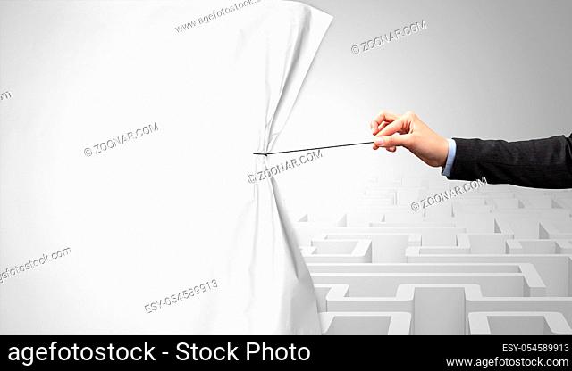 Hand pulling paper curtain, changing scene concept