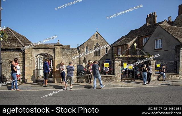 Malmesbury, Wiltshire, England, Pick up point for school children during Covid-19. Parents social distancing outside St Aldhelms Catholic Church to collect...