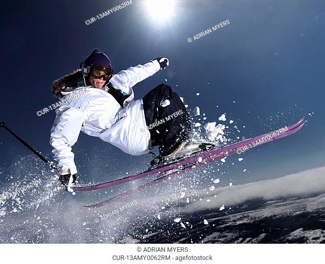 Man grabbing ski tail mid air