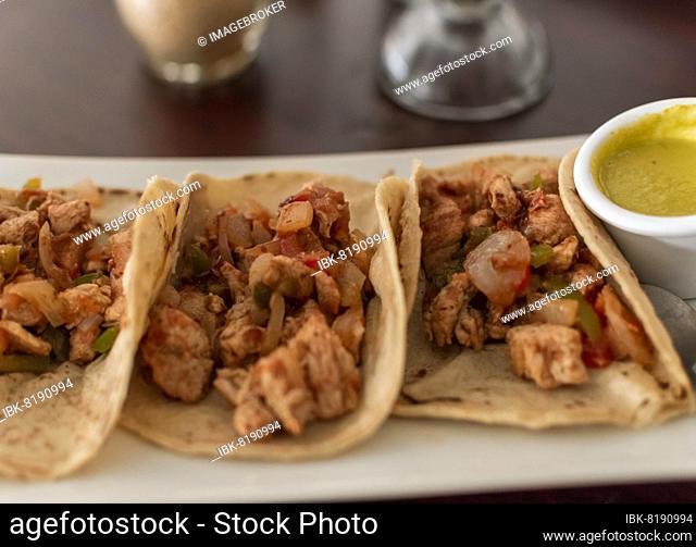 Close up of mexican chicken tacos, chicken tacos with salsa served on the table, tacos served on the table