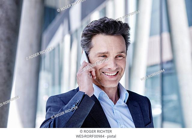 Portrait of smiling businessman on the phone