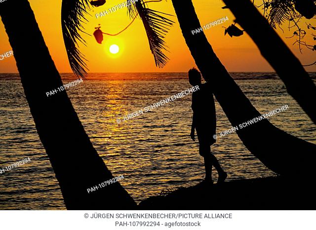 Sunset on the holiday island Hudhuran Fushi of the Maldives. The island in the North Male Atoll is one of the few of the elongated chain of islands on which...