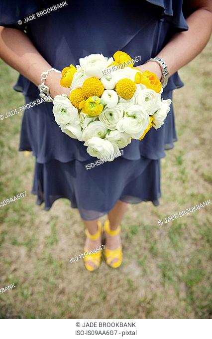Bridesmaid with yellow bouquet and shoes