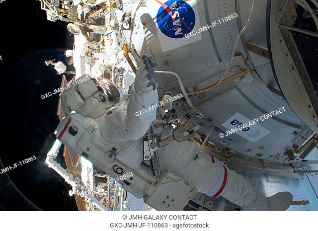 Astronaut Mike Foreman, STS-129 mission specialist, works near the Columbus laboratory during the mission's first session of extravehicular activity (EVA) as...