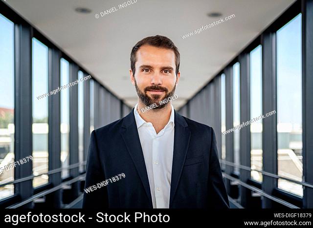 Young businessman standing on elevated walkway