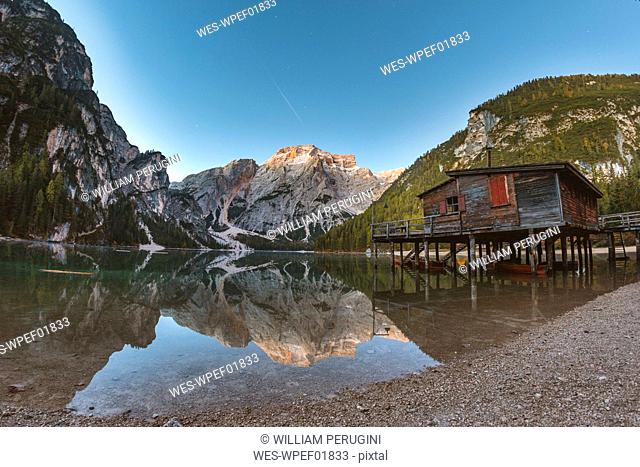 Scenic view of Braies lake against clear blue sky during sunrise, Italy