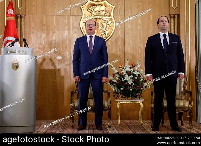 28 February 2020, Tunisia, Carthage: Tunisian new Prime Minister Elyes Fakhfakh (L) and former Prime Minister Youssef Chahed attend a government handover...