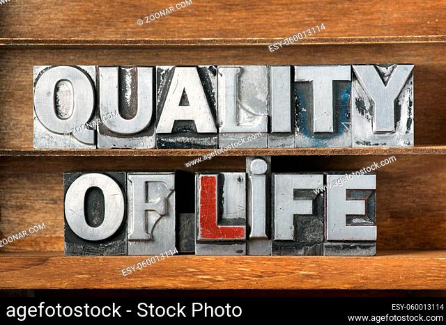 quality of life phrase made from metallic letterpress type on wooden tray