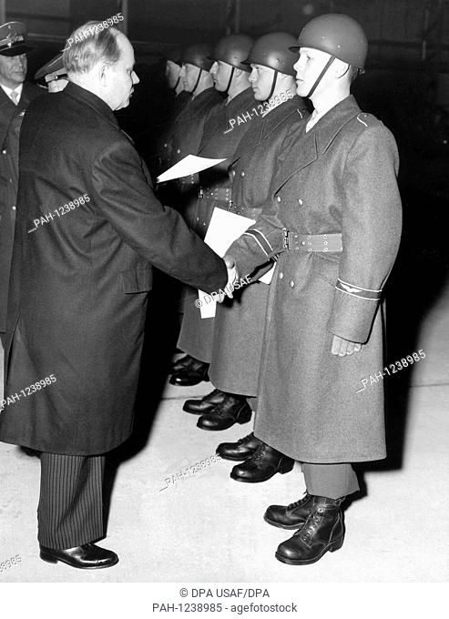 German defence minister Theodor Blank (l) hands over letters of appointment on the 9th of January in 1956 to the first soldiers of the air foce