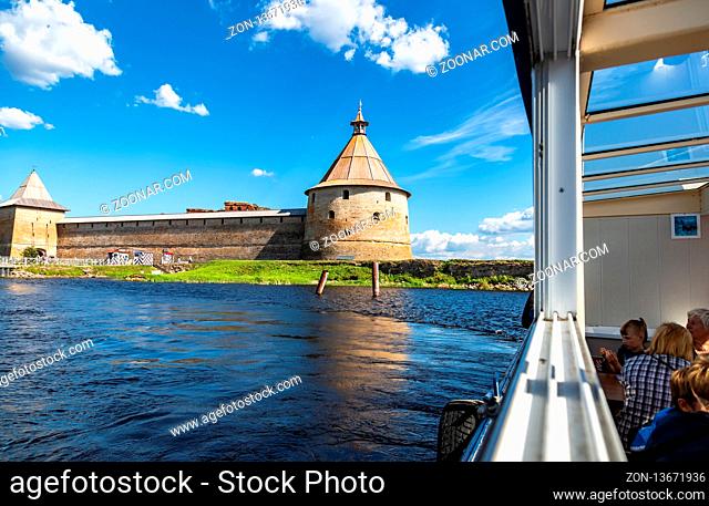 Shlisselburg, Russia - August 8, 2018: River cruise ship sailing on the Neva river to historical fortress Oreshek in summer sunny day